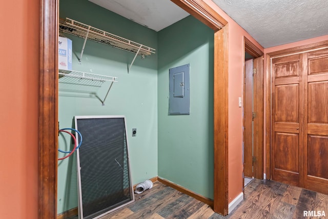 laundry area featuring washer hookup, electric dryer hookup, dark hardwood / wood-style floors, electric panel, and a textured ceiling