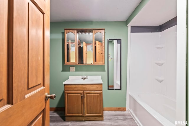 bathroom with vanity, hardwood / wood-style flooring, and shower / bathtub combination