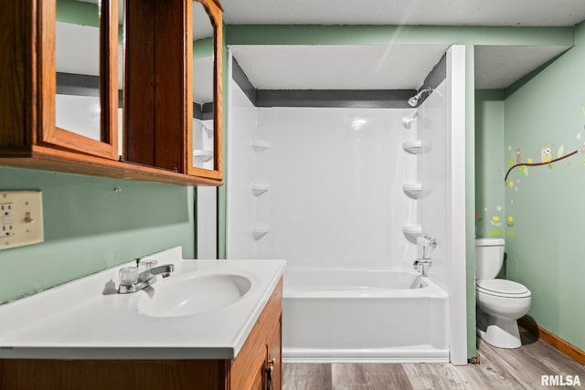 full bathroom featuring wood-type flooring, vanity, bathing tub / shower combination, and toilet