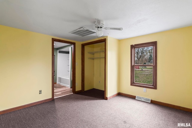 unfurnished bedroom featuring ceiling fan, a closet, and carpet