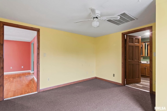 empty room featuring hardwood / wood-style floors and ceiling fan