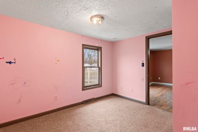 empty room featuring a textured ceiling and hardwood / wood-style flooring