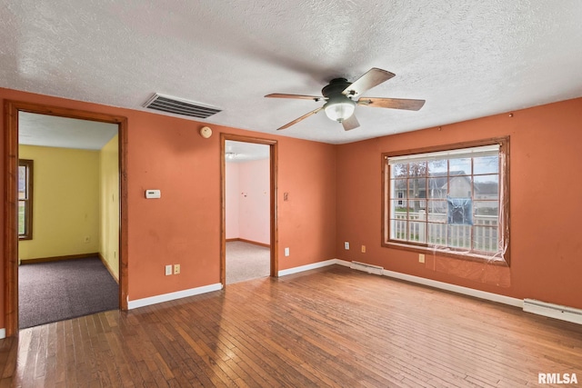 spare room with hardwood / wood-style flooring, ceiling fan, and a textured ceiling