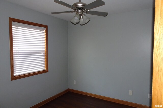 1130 Adams St, Quincy, IL 62301 - empty room with dark wood-style floors and a ceiling fan