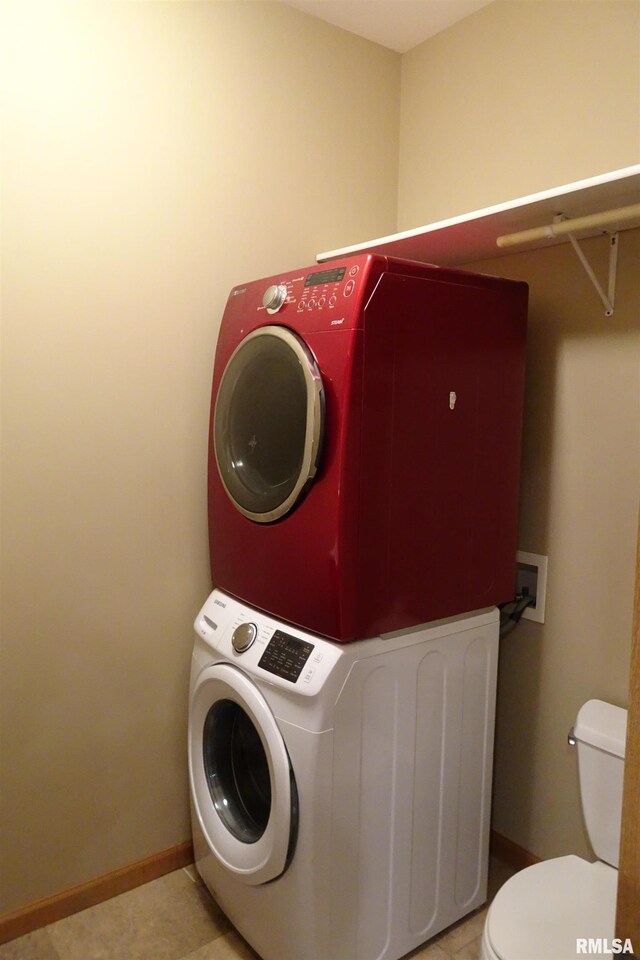 1130 Adams St, Quincy, IL 62301 - laundry room featuring stacked washing machine and dryer and light tile patterned floors