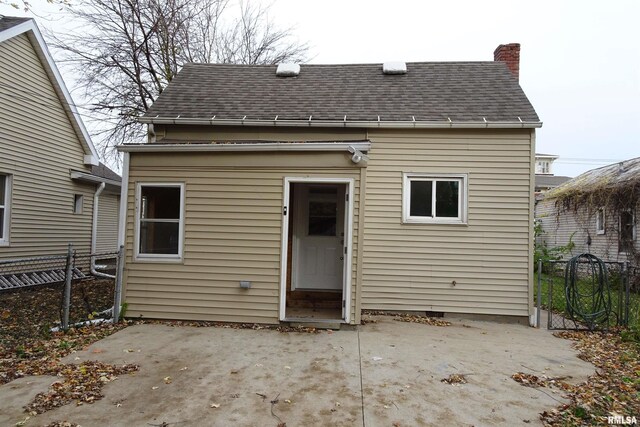 1130 Adams St, Quincy, IL 62301 - rear view of house with roof with shingles, a patio, and a chimney