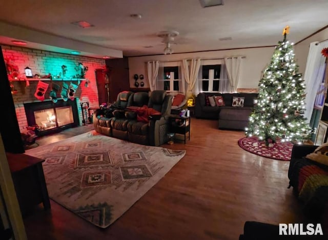 cinema room with a fireplace and hardwood / wood-style flooring