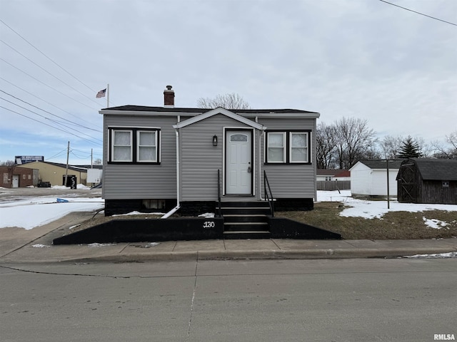 view of front facade featuring a shed