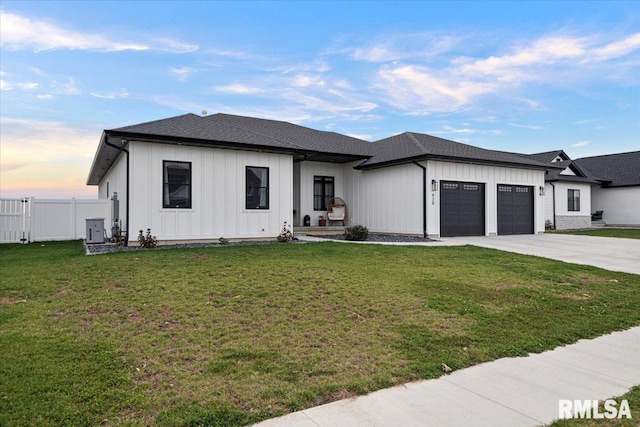 view of front of house featuring a garage and a lawn