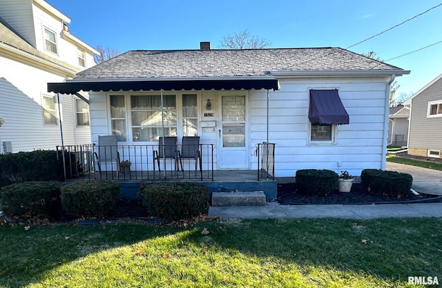 bungalow-style home with a porch and a front lawn