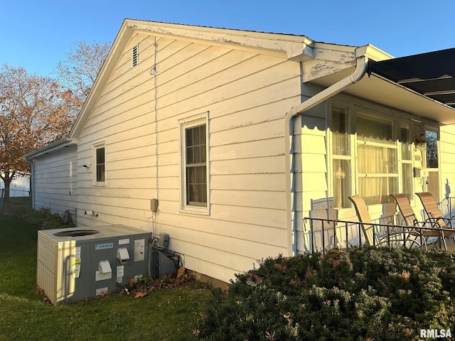 view of side of home with central AC unit