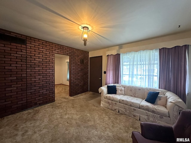 carpeted living room with brick wall