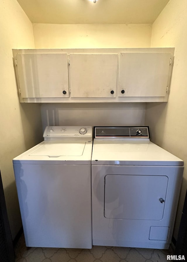 laundry room with cabinets and washer and clothes dryer