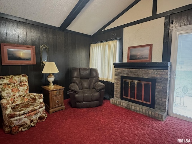 living area with vaulted ceiling, wooden walls, a wealth of natural light, a fireplace, and a textured ceiling