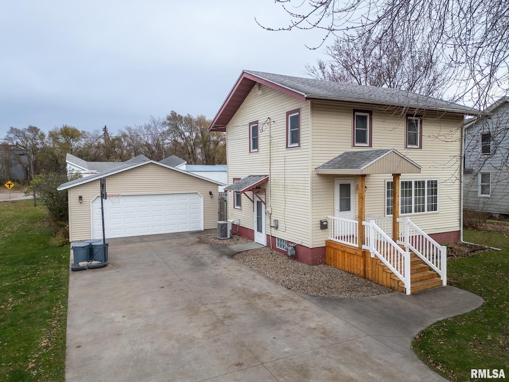 front of property with a garage, an outdoor structure, and cooling unit