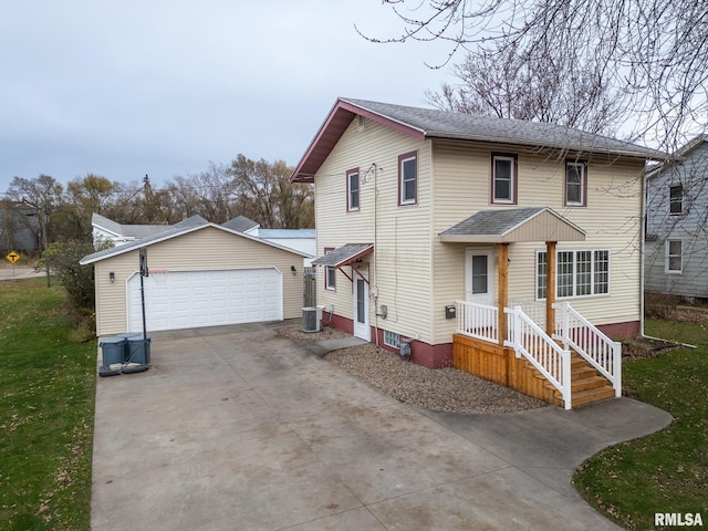 front of property with a garage, an outdoor structure, and cooling unit