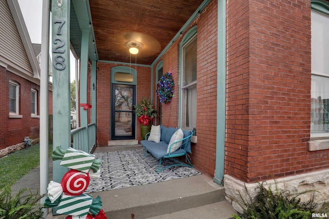 view of exterior entry with covered porch