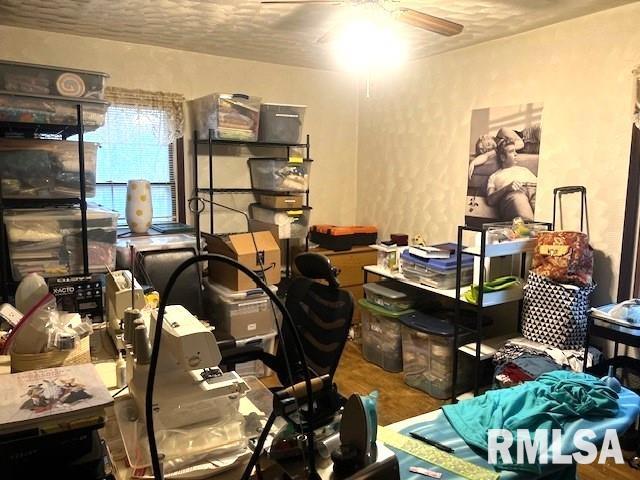 miscellaneous room with ceiling fan, a textured ceiling, and hardwood / wood-style flooring