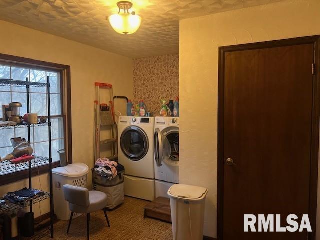 clothes washing area featuring independent washer and dryer and a textured ceiling