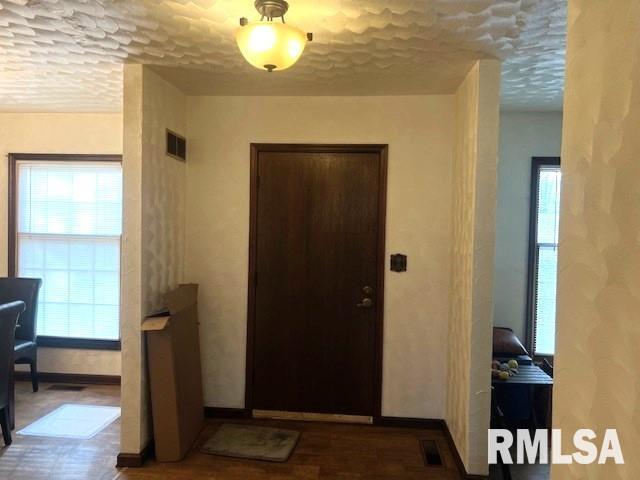 entryway with a textured ceiling