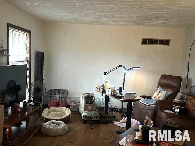 living area featuring hardwood / wood-style floors and a textured ceiling