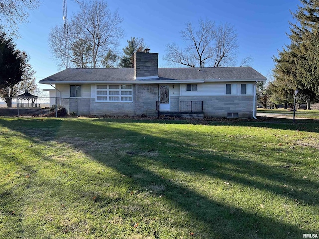 rear view of property featuring a lawn