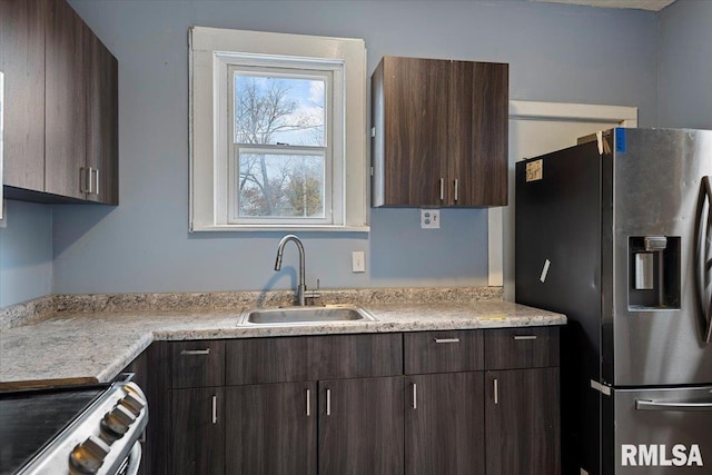 kitchen with sink, dark brown cabinetry, and stainless steel appliances