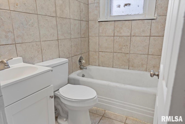 full bathroom with tub / shower combination, vanity, tile walls, tile patterned flooring, and toilet