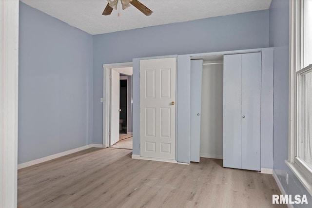 unfurnished bedroom with ceiling fan, light hardwood / wood-style floors, and a textured ceiling