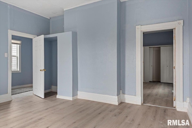 unfurnished bedroom featuring a closet and light wood-type flooring