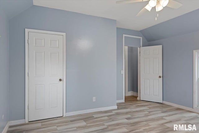 unfurnished bedroom featuring ceiling fan, light hardwood / wood-style floors, lofted ceiling, and a closet