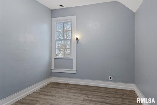 unfurnished room with wood-type flooring and vaulted ceiling