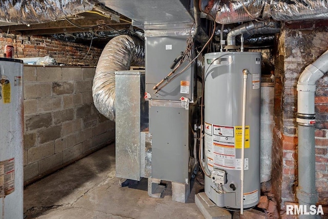 utility room with heating unit and water heater