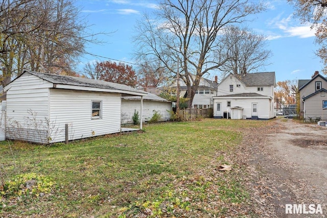 back of property featuring a lawn