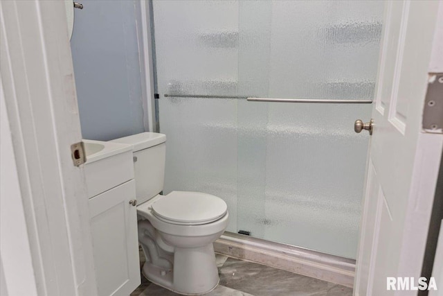 bathroom featuring tile patterned flooring, a shower with door, vanity, and toilet