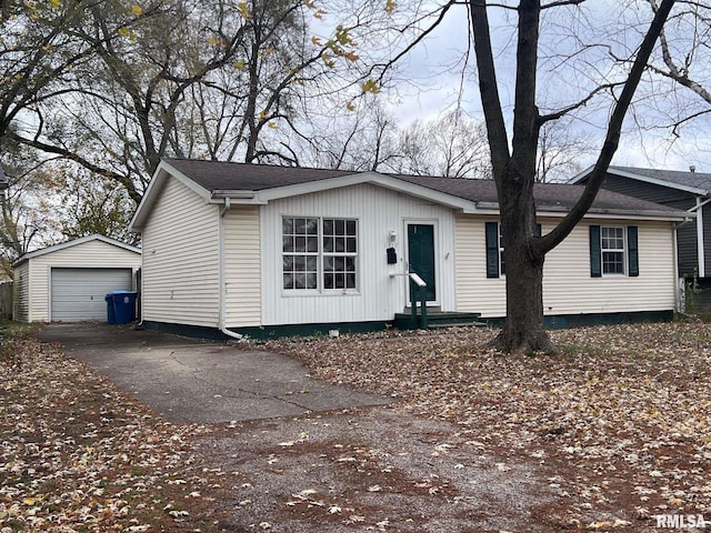 view of front of home with a garage and an outbuilding