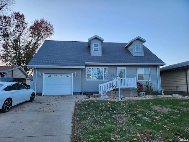 view of front of house featuring a garage and a front lawn