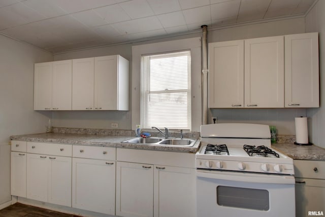 kitchen featuring white cabinetry, sink, and gas range gas stove