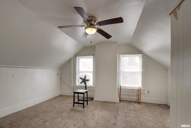 additional living space with ceiling fan, lofted ceiling, and light carpet