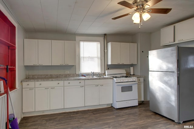 kitchen featuring stainless steel fridge, white cabinetry, and white range with gas cooktop