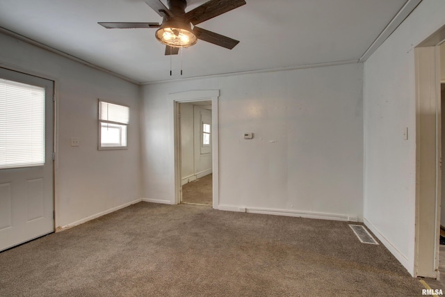 spare room with carpet, ceiling fan, and ornamental molding