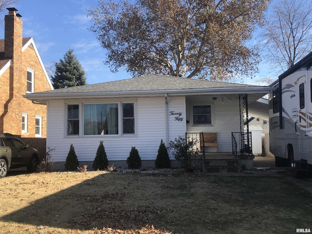 bungalow-style house with roof with shingles and a porch