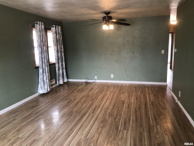 empty room with hardwood / wood-style floors and ceiling fan