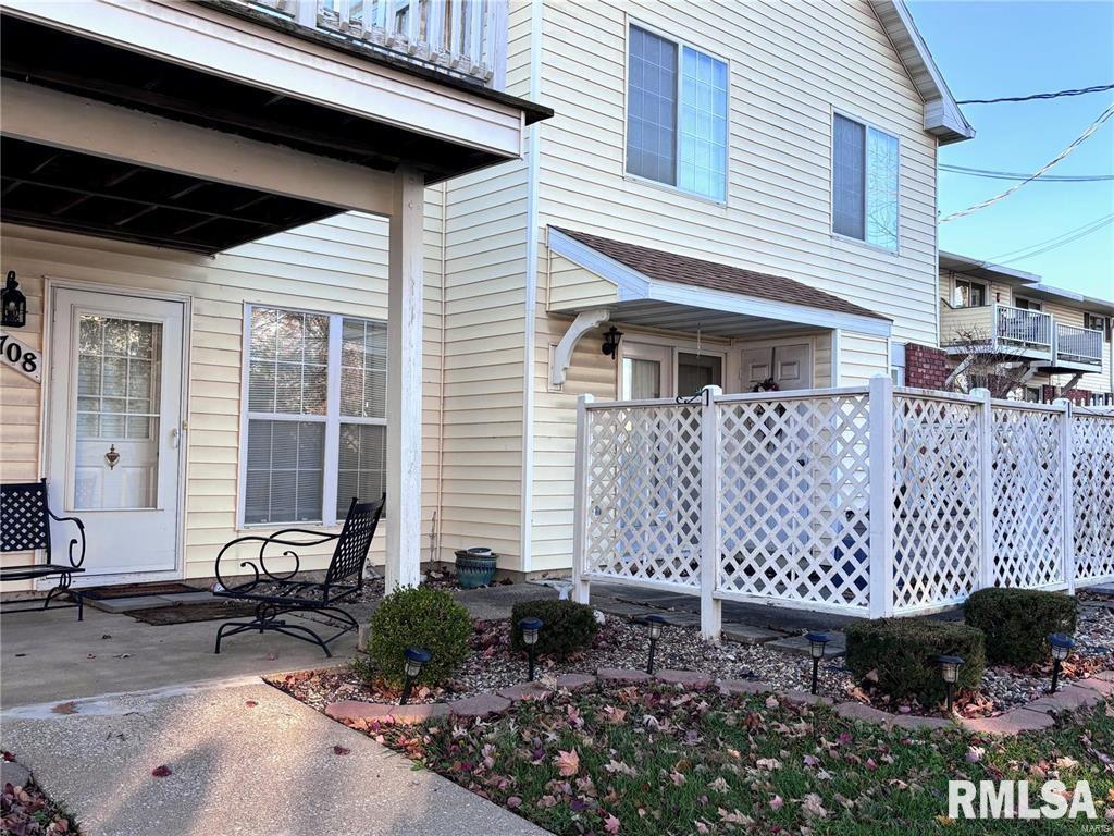 exterior space with a balcony and fence