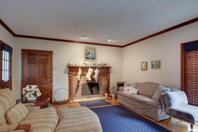 living room with a fireplace, crown molding, and hardwood / wood-style floors