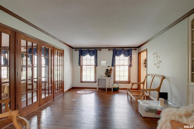 sitting room featuring dark hardwood / wood-style flooring, crown molding, and french doors