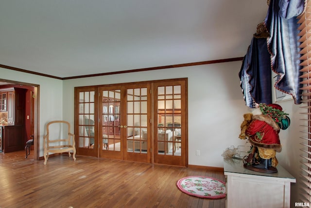 sitting room featuring a healthy amount of sunlight, french doors, and hardwood / wood-style floors