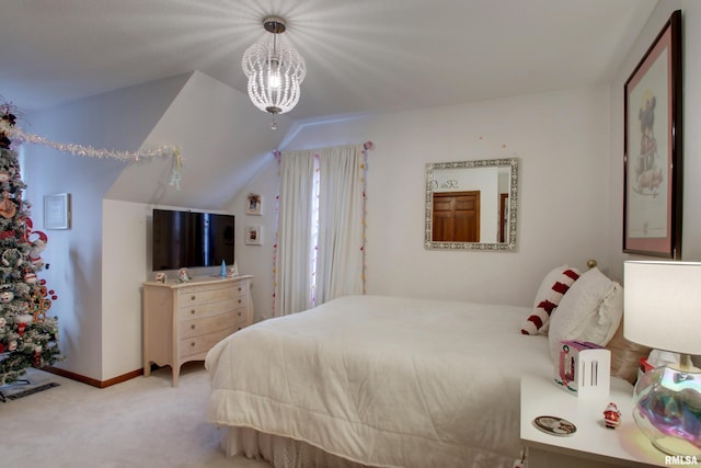 carpeted bedroom featuring a notable chandelier and lofted ceiling