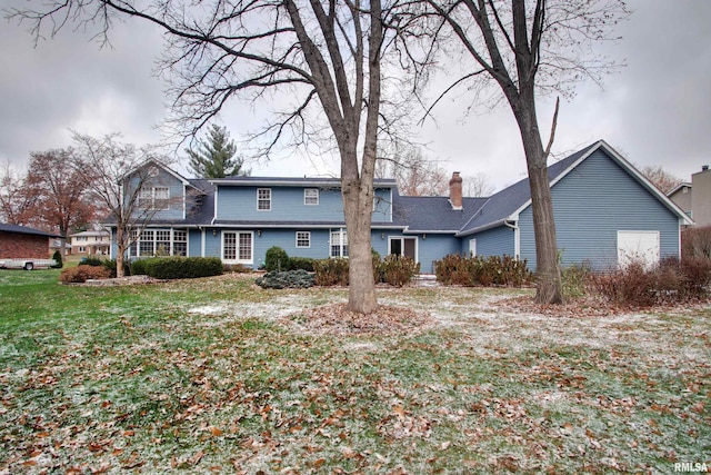 back of house featuring a yard