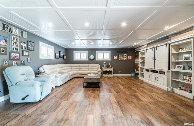 living room with wood-type flooring and coffered ceiling